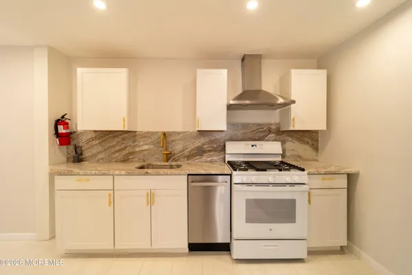 a stove top oven sitting inside of a kitchen