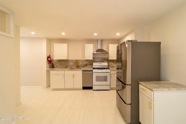 a kitchen with a refrigerator a sink and cabinets