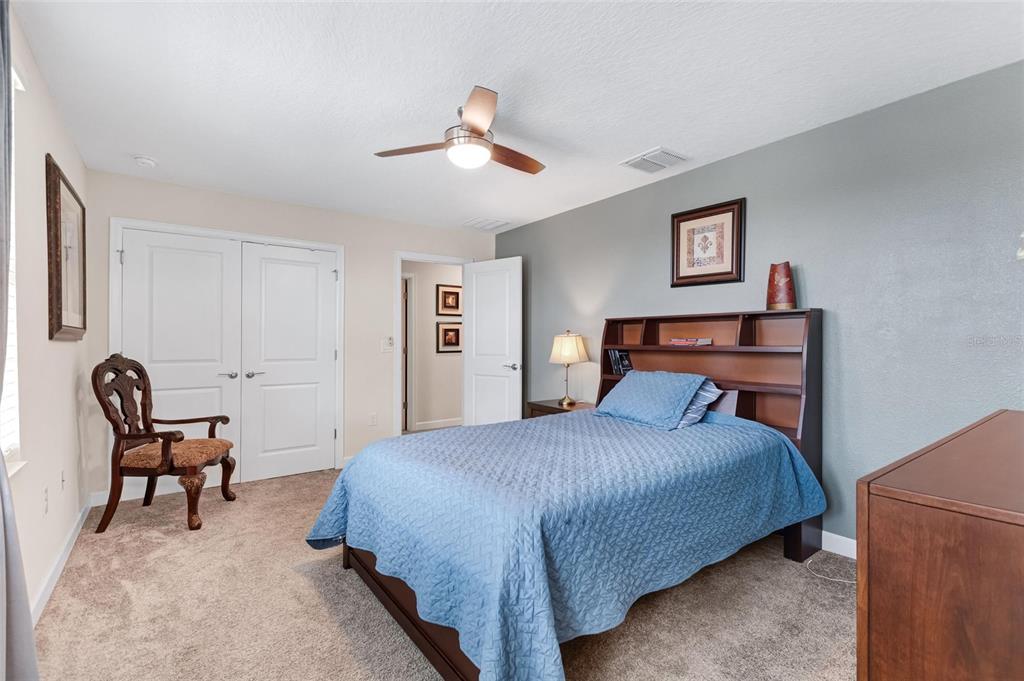 1089 Blackwolf Run Road Davenport, FL 33896 - Photo 31 of 82 a bedroom with a bed a chair and a dresser