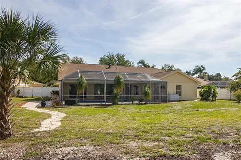 a view of a house with a yard patio and swimming pool