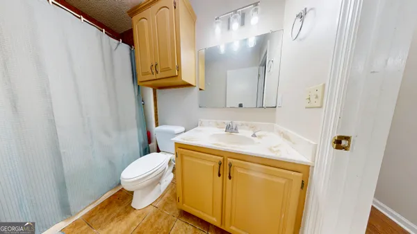 a bathroom with a sink toilet and mirror