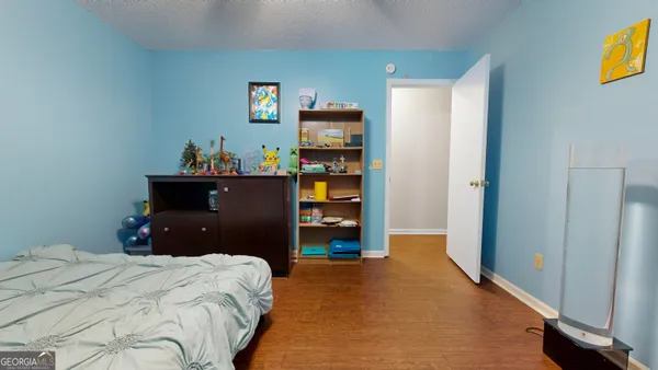 a bedroom with a bed and a television