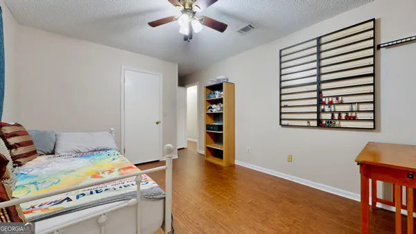 a bedroom with a bed and a bookshelf