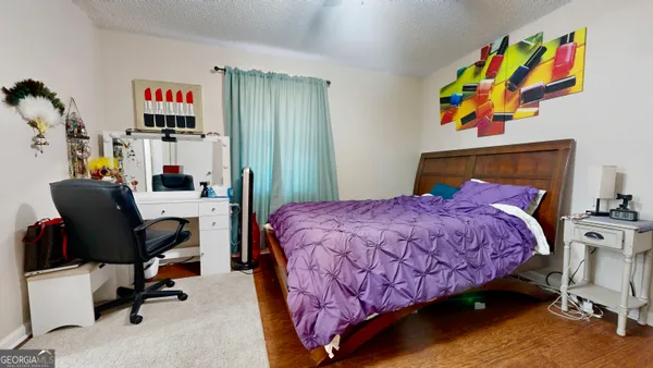 a bed room with a bed and a chair