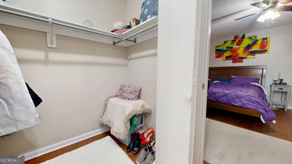 a bedroom with a bed and a painting on the wall