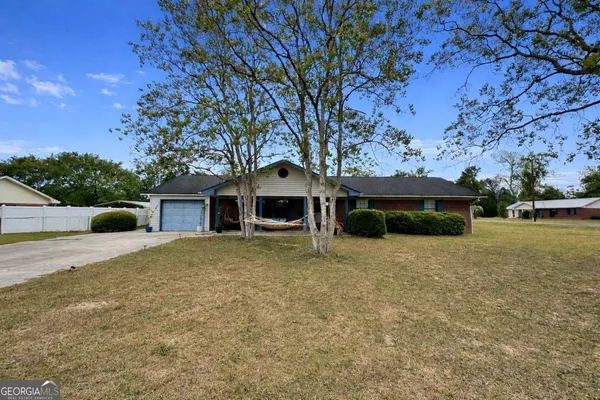 a front view of a house with a garden