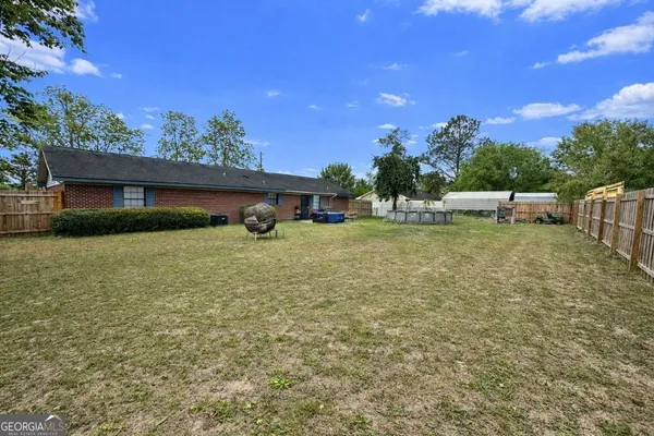 a view of a house with outdoor space and sitting area