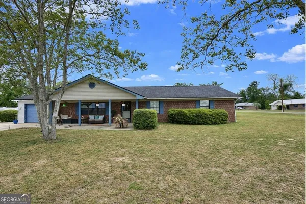 a front view of a house with garden