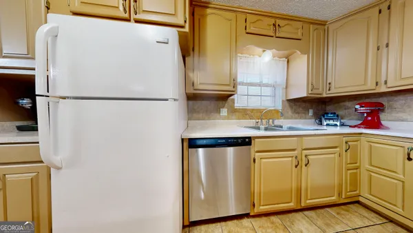a white refrigerator freezer sitting in a kitchen