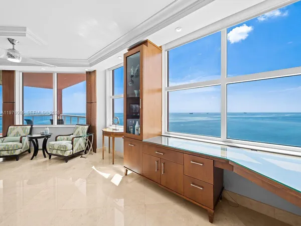 a living room with furniture and a mirror