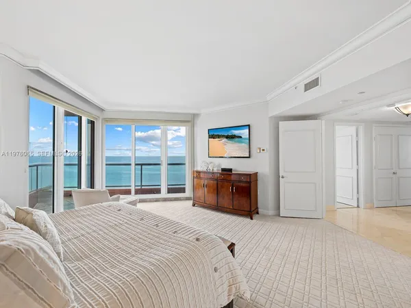 a spacious bedroom with a bed and a large window