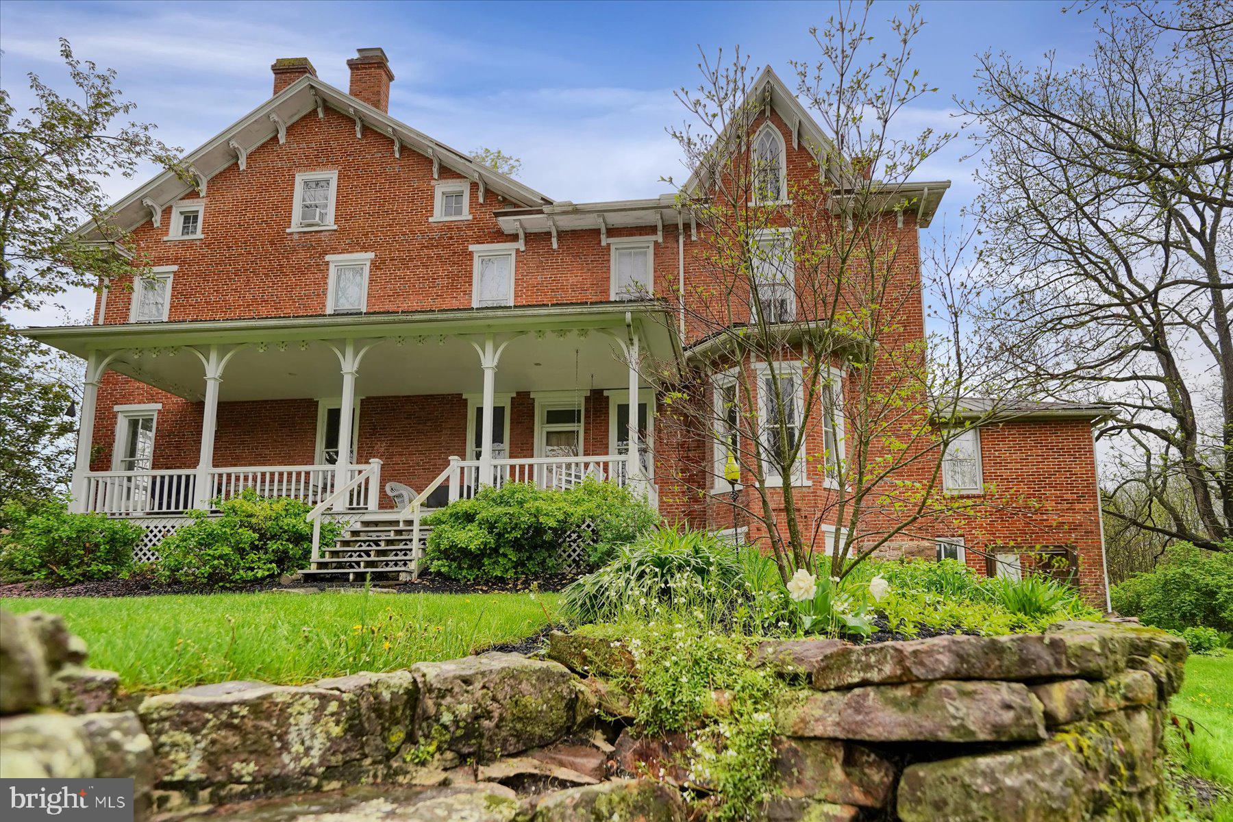 612 Old Rte 322 Spring Mills, PA 16875 - Photo 48 of 78 a front view of a house with a yard and potted plants