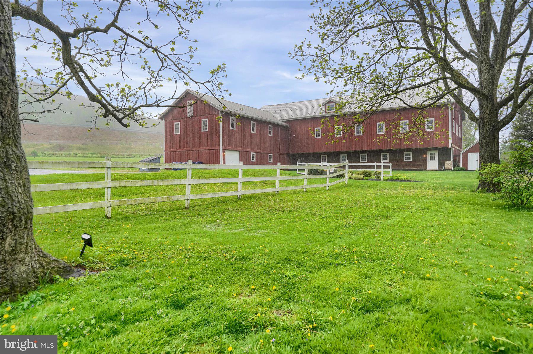 612 Old Rte 322 Spring Mills, PA 16875 - Photo 50 of 78 a front view of a house with a garden and trees