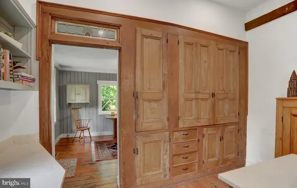 a dining room with furniture a chandelier and wooden floor