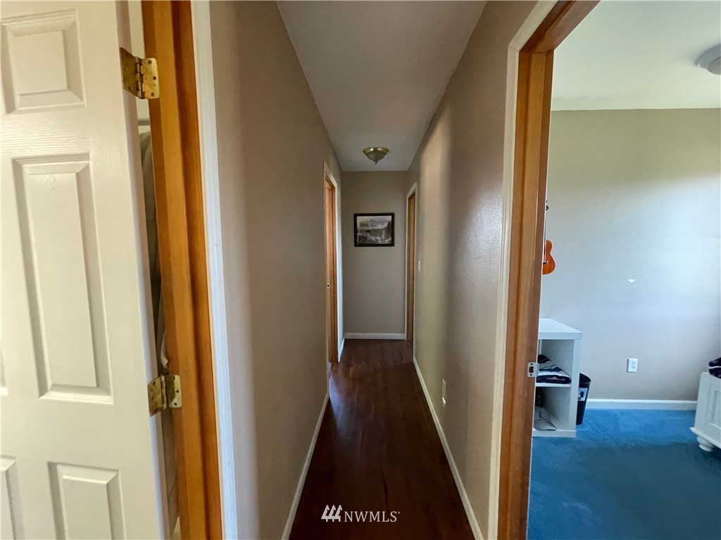 182 West Valley Road Chimacum, WA 98325 - Photo 11 of 35 a view of a hallway with wooden floor and stairs