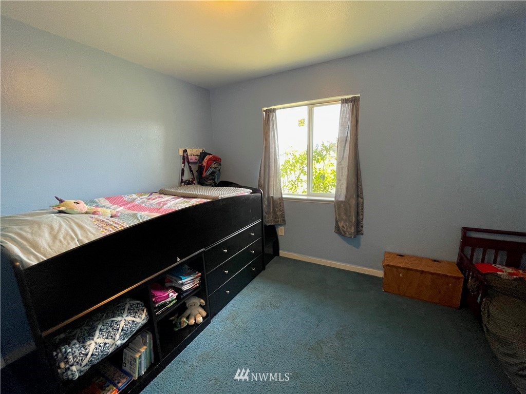 182 West Valley Road Chimacum, WA 98325 - Photo 16 of 35 a bed sitting in a bedroom next to a window