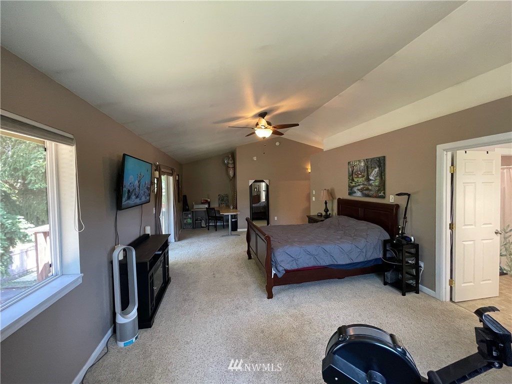 182 West Valley Road Chimacum, WA 98325 - Photo 19 of 35 a bedroom with furniture and a flat screen tv