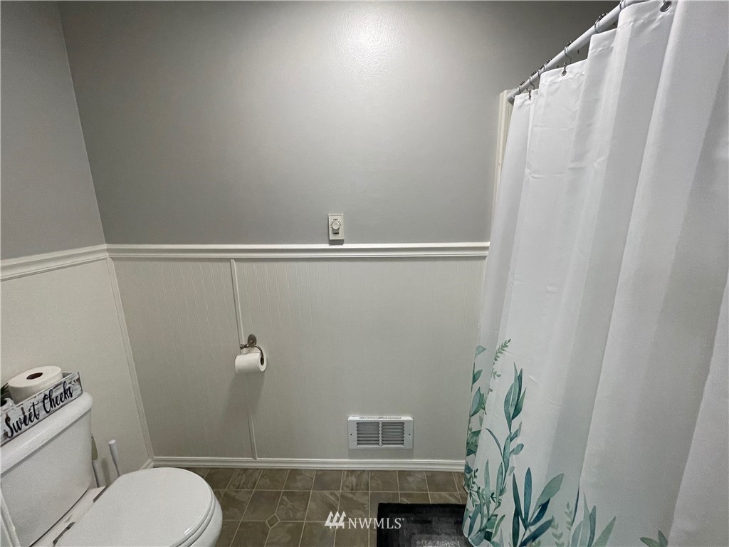 182 West Valley Road Chimacum, WA 98325 - Photo 21 of 35 a bathroom with a shower curtain and a toilet
