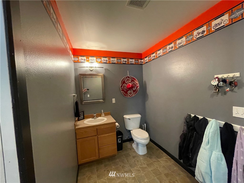 182 West Valley Road Chimacum, WA 98325 - Photo 26 of 35 a bathroom with a sink mirror vanity and toilet