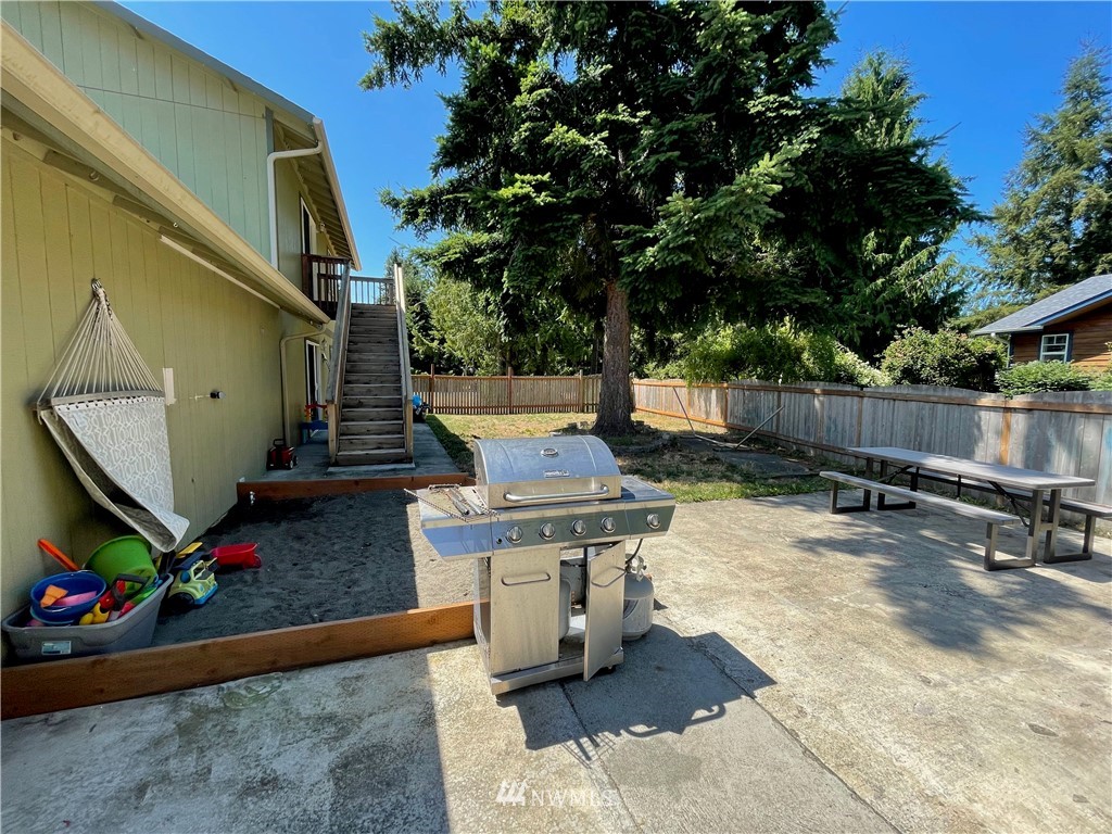 182 West Valley Road Chimacum, WA 98325 - Photo 27 of 35 a view of a patio with table and chairs and potted plants