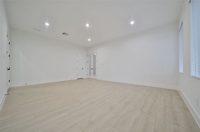 an empty room with windows and closet