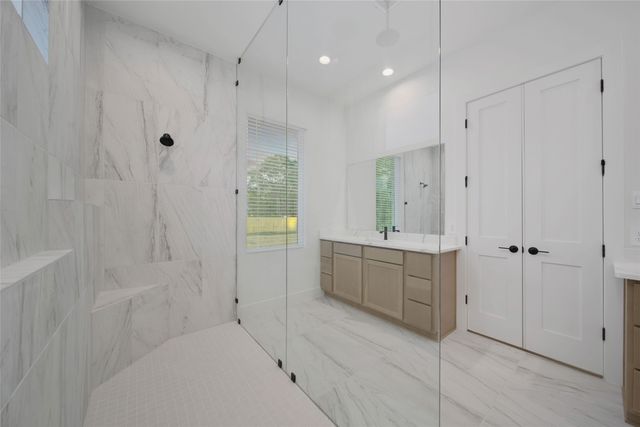 a bathroom with a shower and a sink