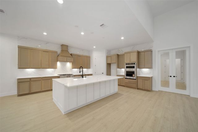 a large white kitchen with a large window