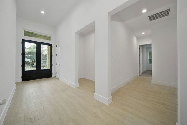a view of an empty room with glass door