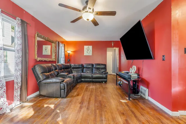 a kitchen with a table chairs refrigerator and microwave