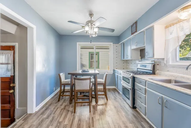 a white house with a granite countertop sink and a window