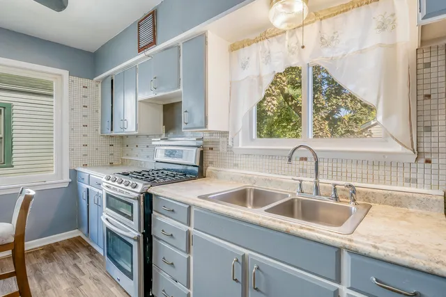 a bathroom with a sink a toilet a mirror and shower