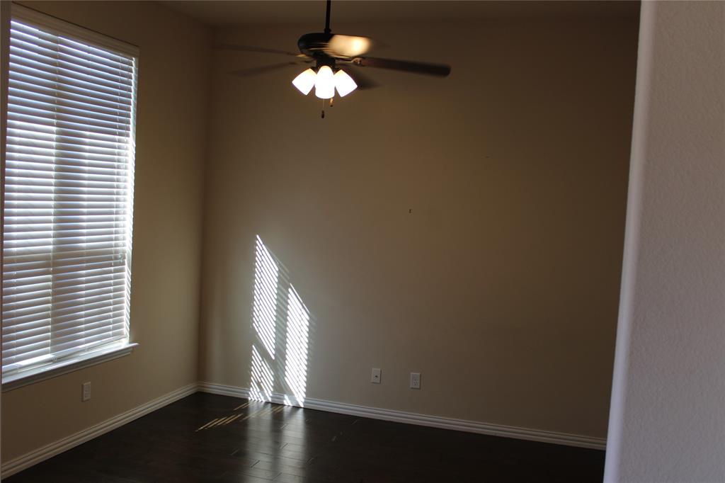 536 Hidden Spgs Trail Azle, TX 76020 - Photo 2 of 21 an empty room with wooden floor and windows