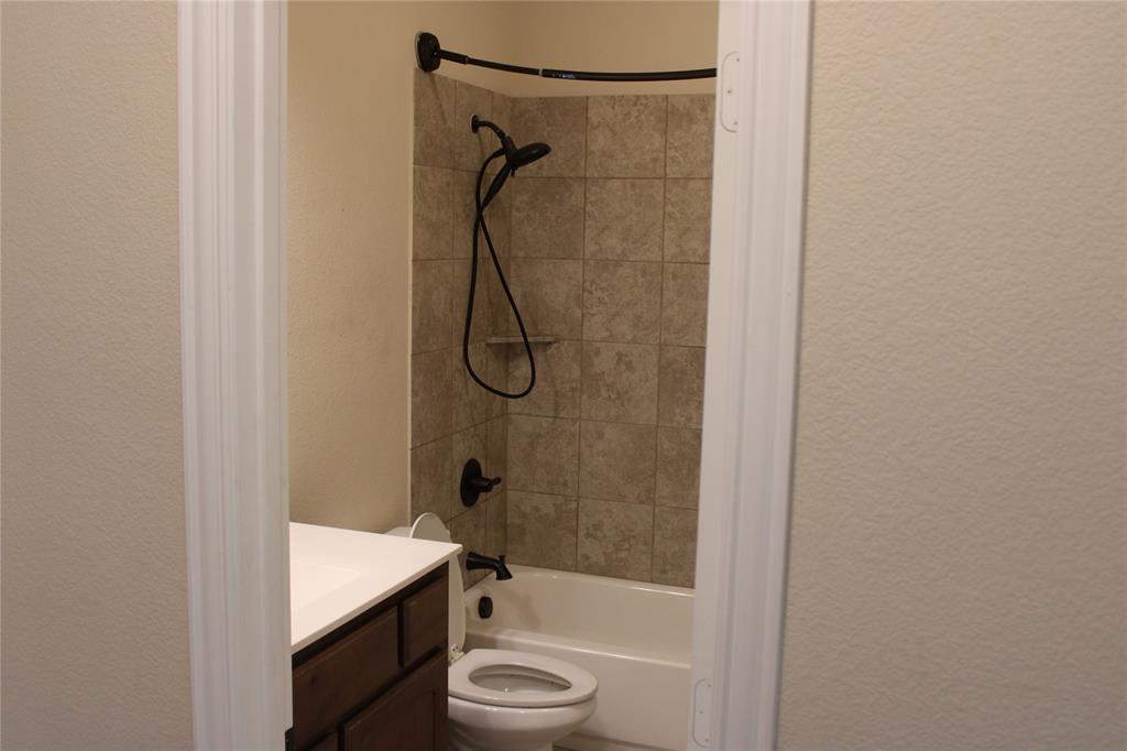 536 Hidden Spgs Trail Azle, TX 76020 - Photo 7 of 21 a bathroom with a shower a toilet and sink