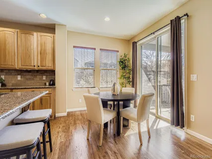 a view of a a dining room with furniture window and wooden floor