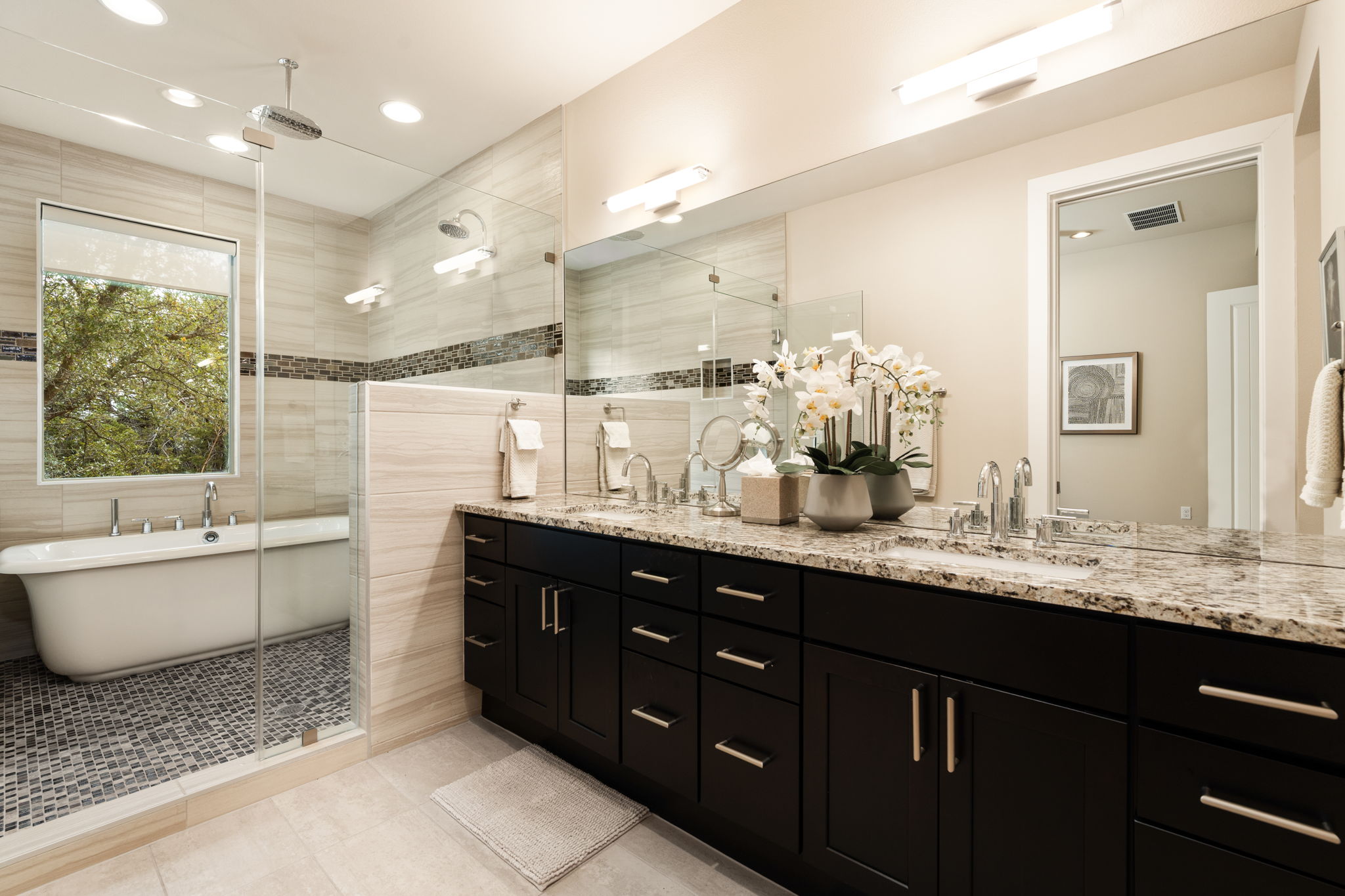 8110 Ranch Road 2222, Unit 81 Austin, TX 78730 - Photo 16 of 28 a bathroom with a granite countertop double vanity sink a mirror and a bathtub