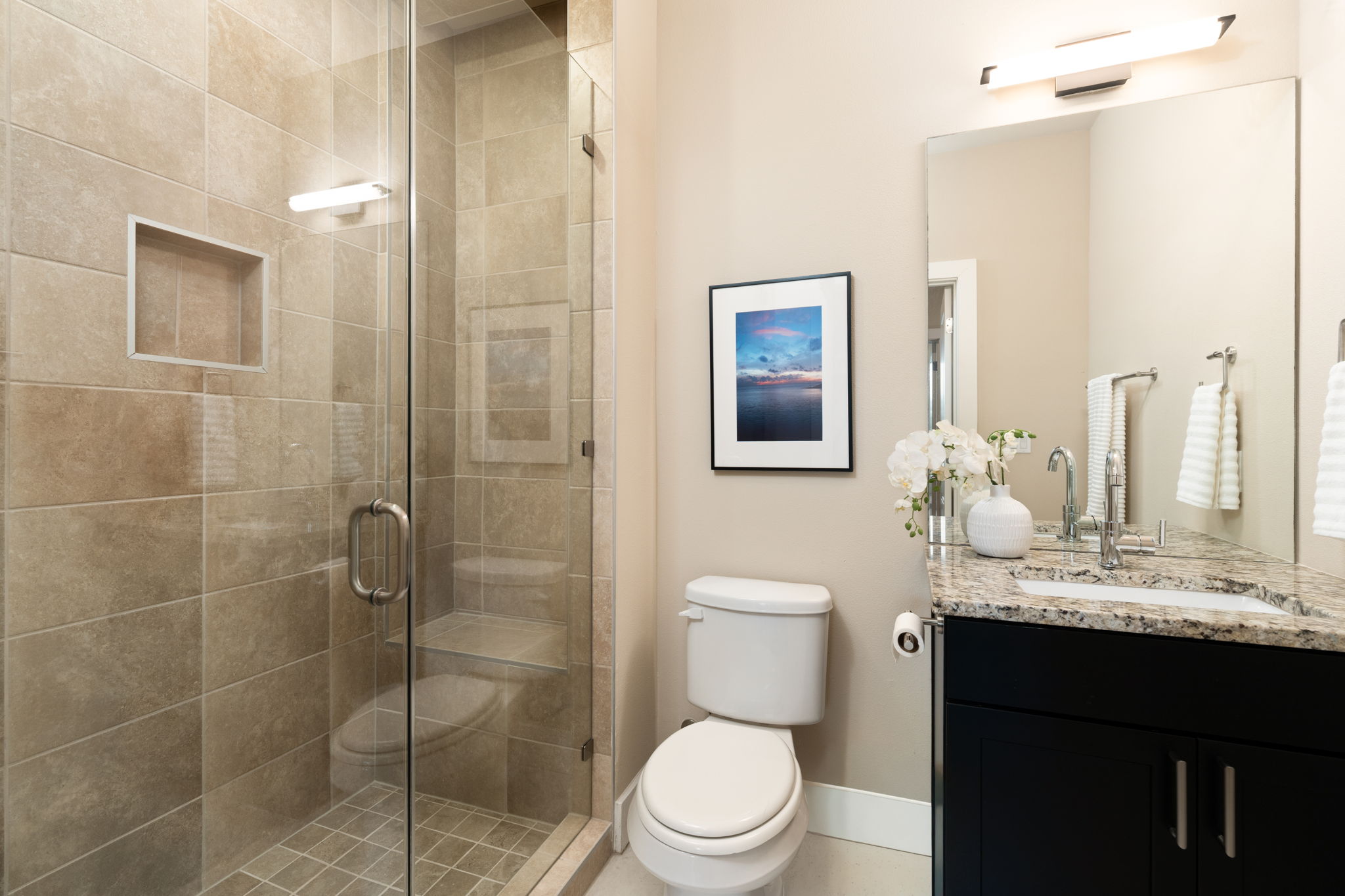 8110 Ranch Road 2222, Unit 81 Austin, TX 78730 - Photo 19 of 28 a bathroom with a granite countertop sink toilet a mirror and shower