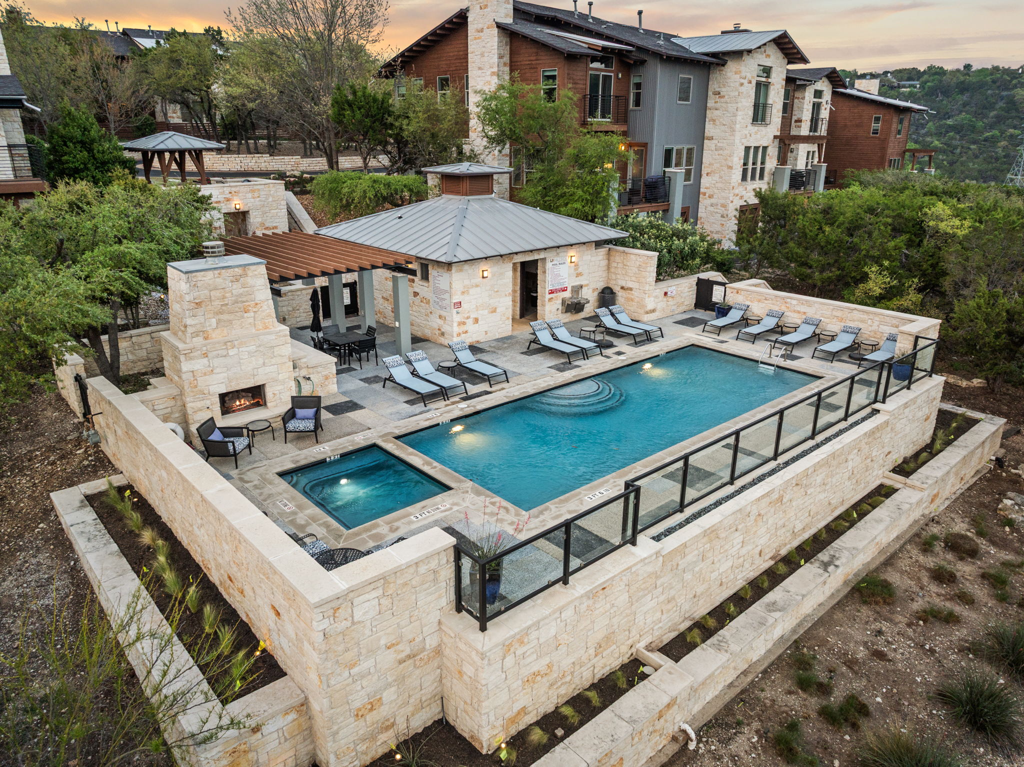 8110 Ranch Road 2222, Unit 81 Austin, TX 78730 - Photo 25 of 28 a view of a patio with table and chairs under an umbrella