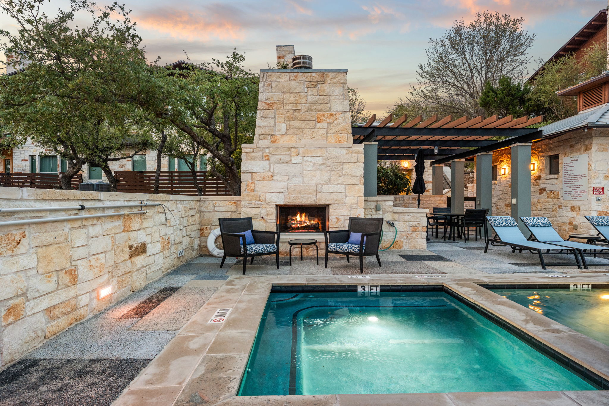 8110 Ranch Road 2222, Unit 81 Austin, TX 78730 - Photo 26 of 28 a view of a patio with dining table and chairs with a fire pit