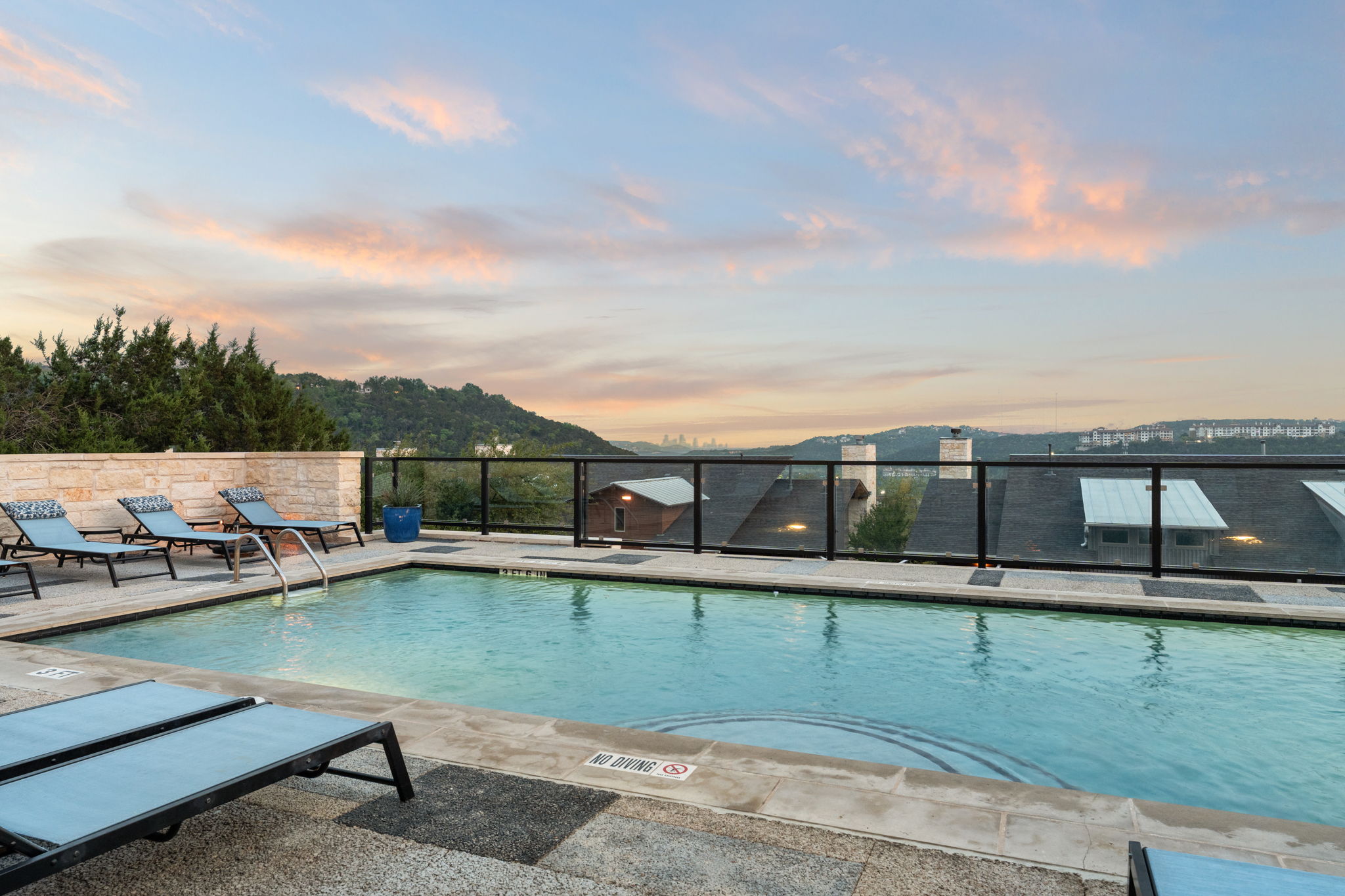 8110 Ranch Road 2222, Unit 81 Austin, TX 78730 - Photo 27 of 28 a view of a swimming pool with lawn chairs