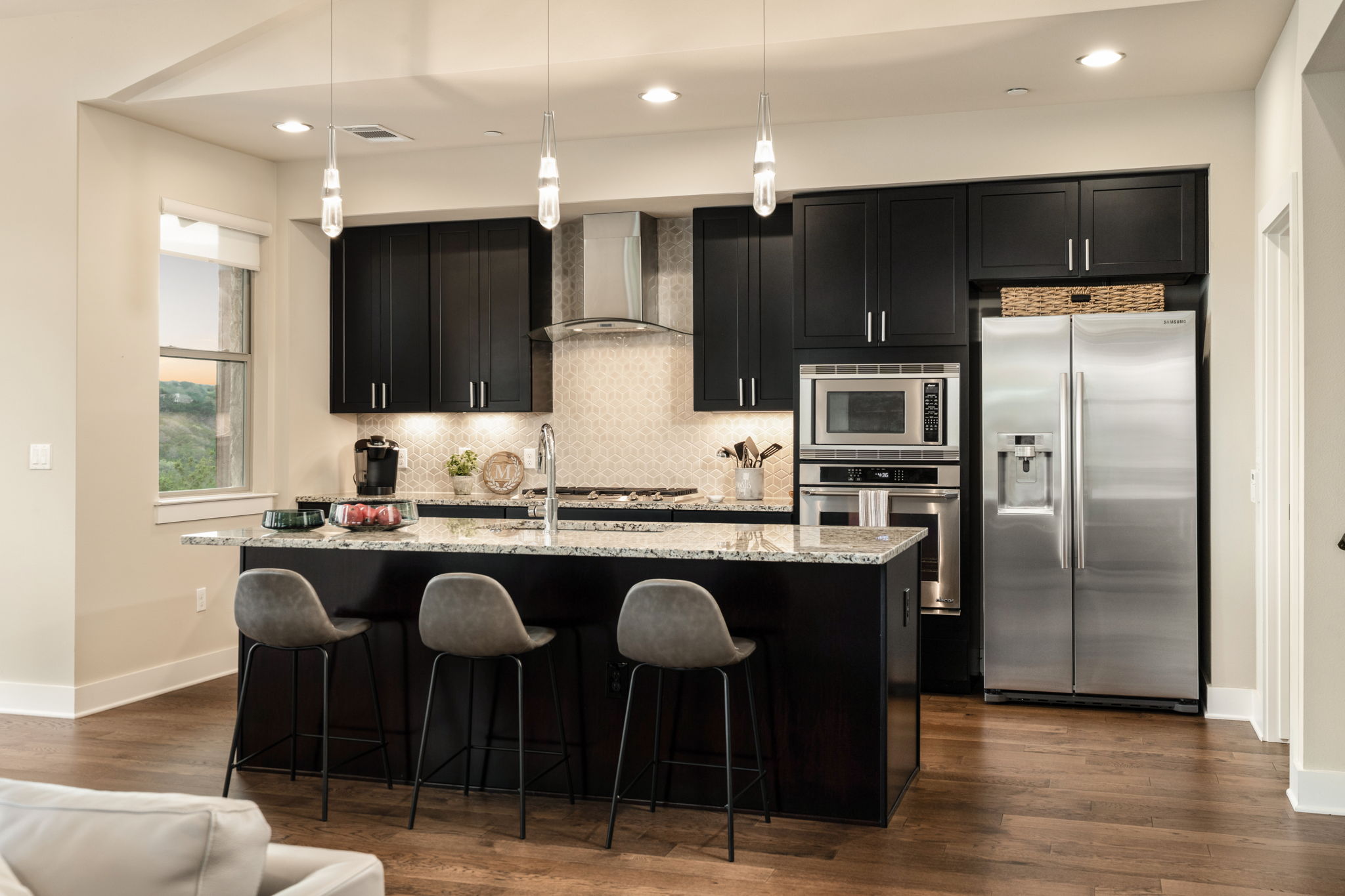 8110 Ranch Road 2222, Unit 81 Austin, TX 78730 - Photo 8 of 28 a kitchen with stainless steel appliances granite countertop a table chairs sink refrigerator and microwave