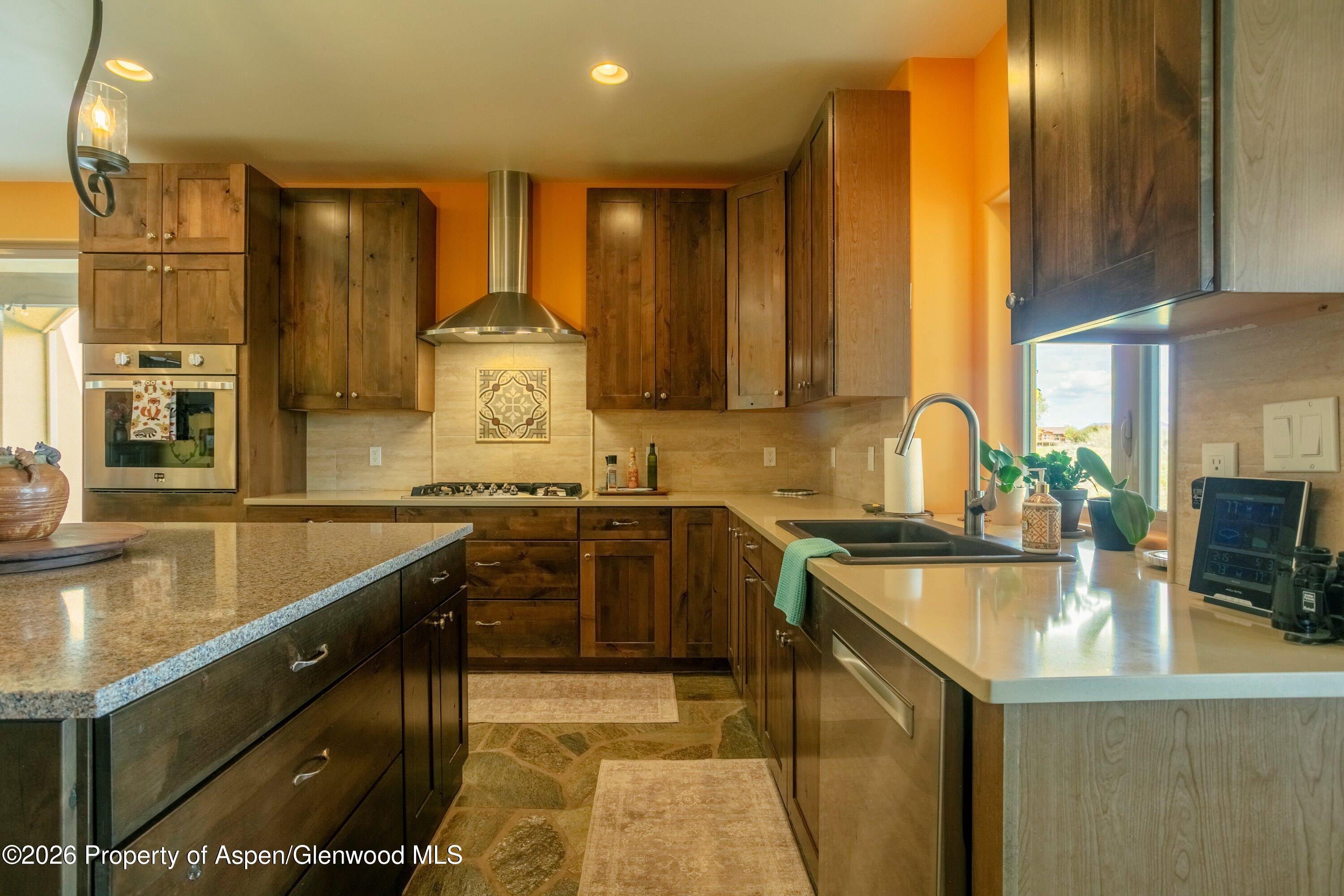 265 South Meadow Drive Rifle, CO 81650 - Photo 50 of 76 a kitchen with stainless steel appliances granite countertop a sink and a stove