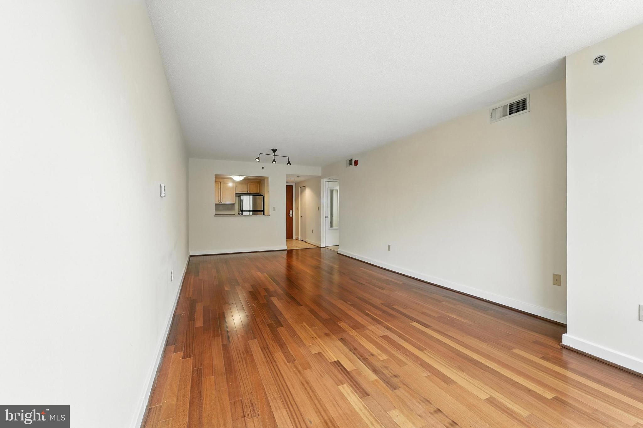 1150 K Street Northwest, Unit 1207 Washington, DC 20005 - Photo 11 of 29 a view of empty room with wooden floor and fan
