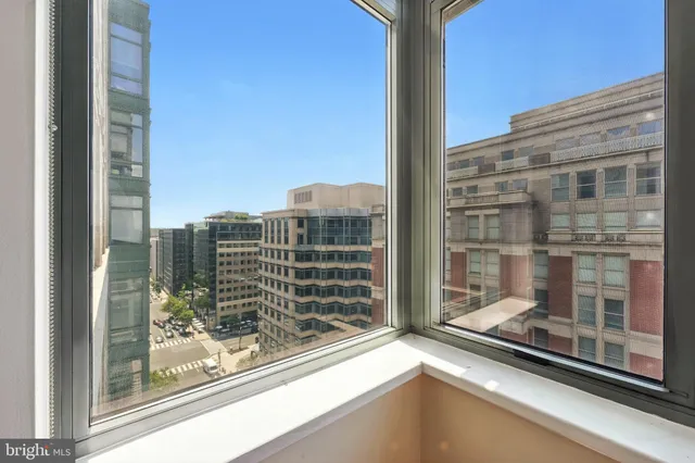 a view of empty room with wooden floor and fireplace