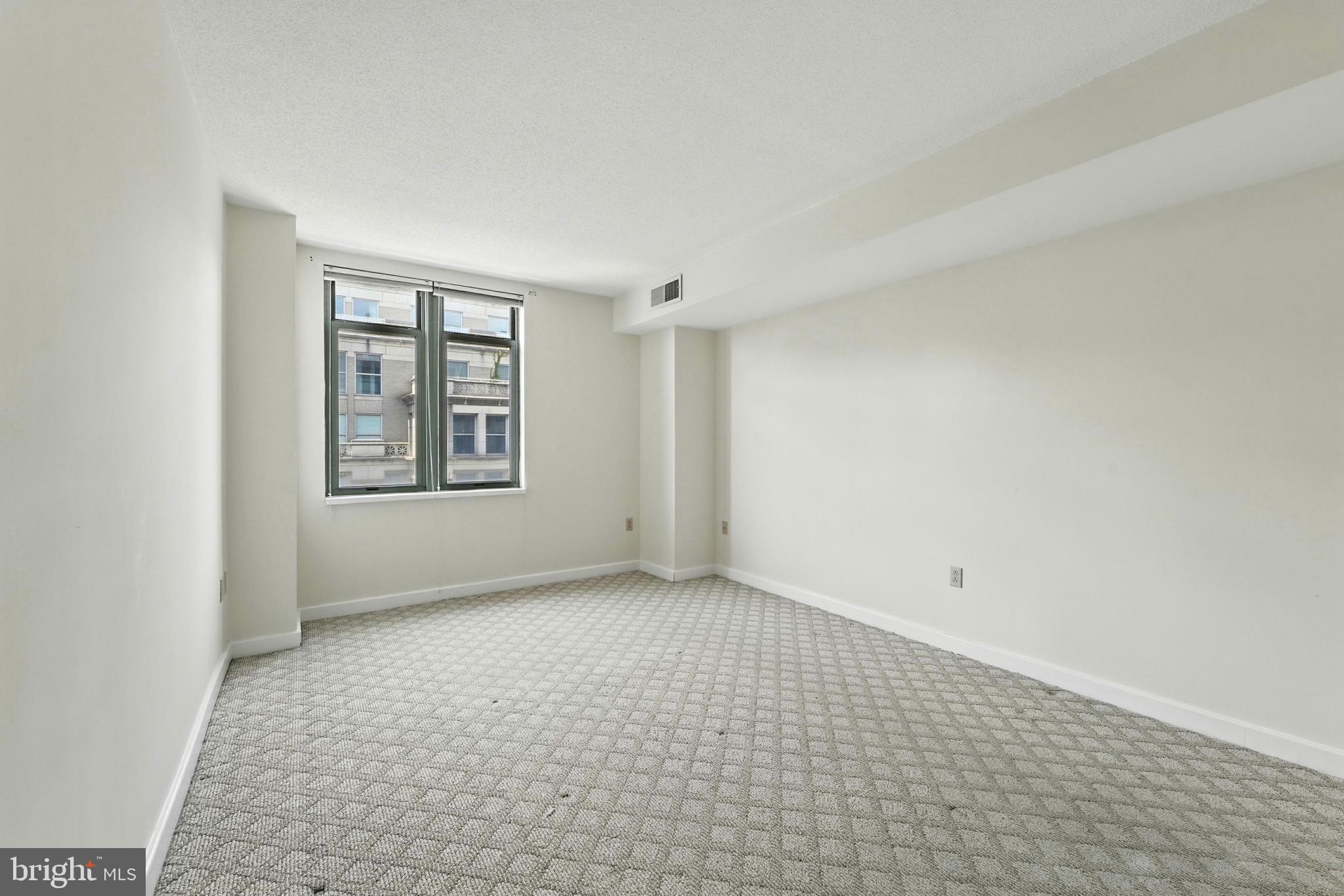 1150 K Street Northwest, Unit 1207 Washington, DC 20005 - Photo 15 of 29 an empty room with windows