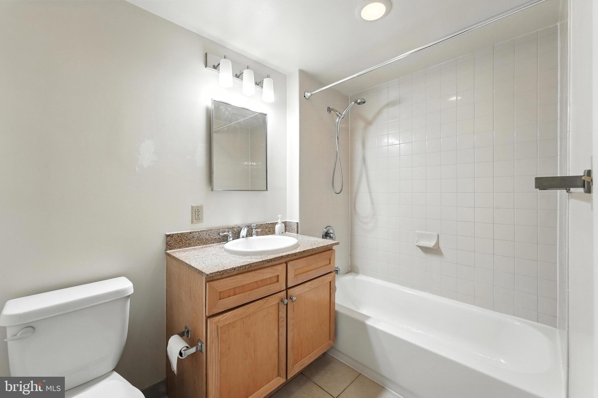 1150 K Street Northwest, Unit 1207 Washington, DC 20005 - Photo 18 of 29 a bathroom with a sink toilet vanity and shower