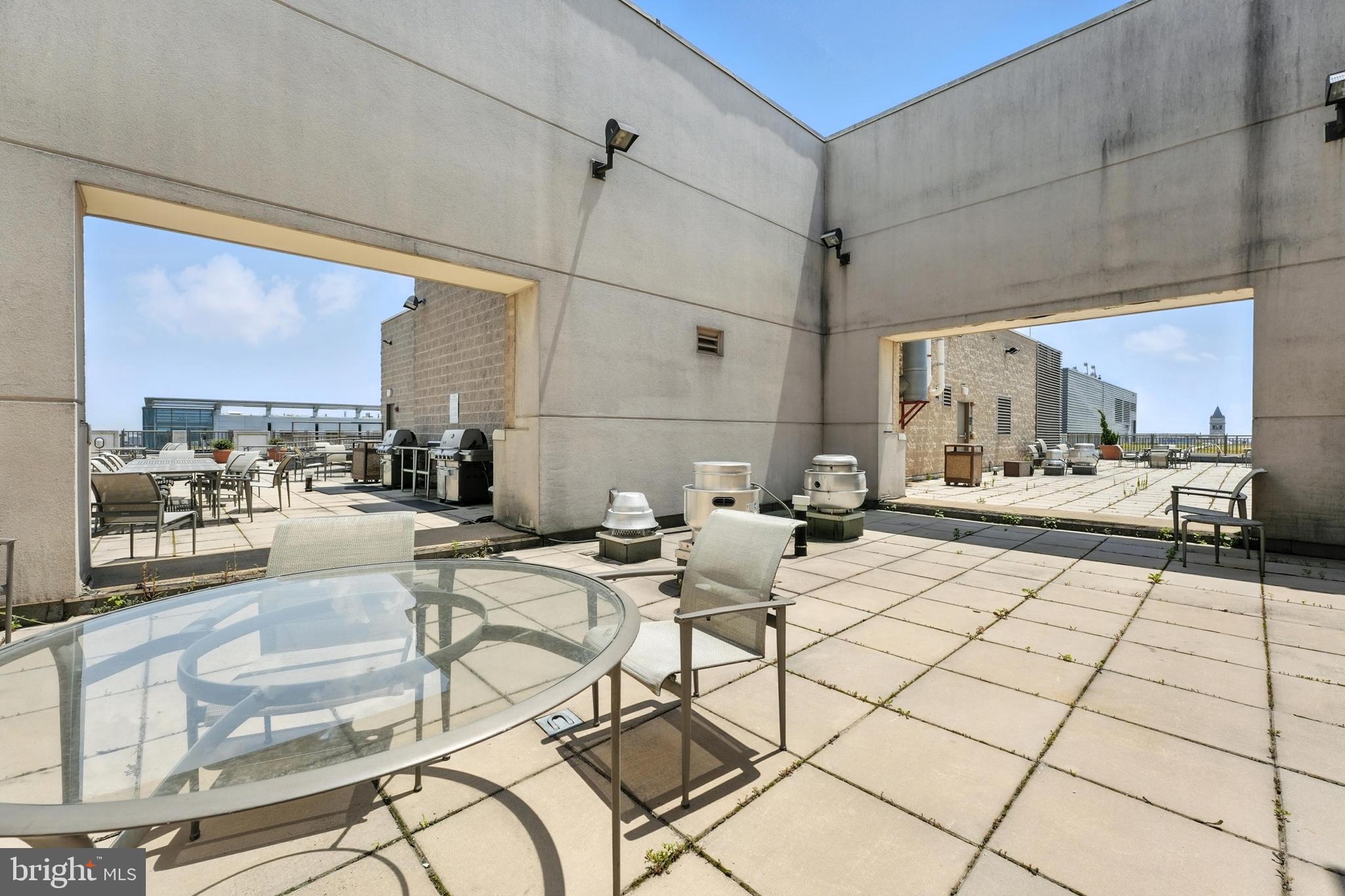 1150 K Street Northwest, Unit 1207 Washington, DC 20005 - Photo 25 of 29 a outdoor space with lots of chairs and mirrors