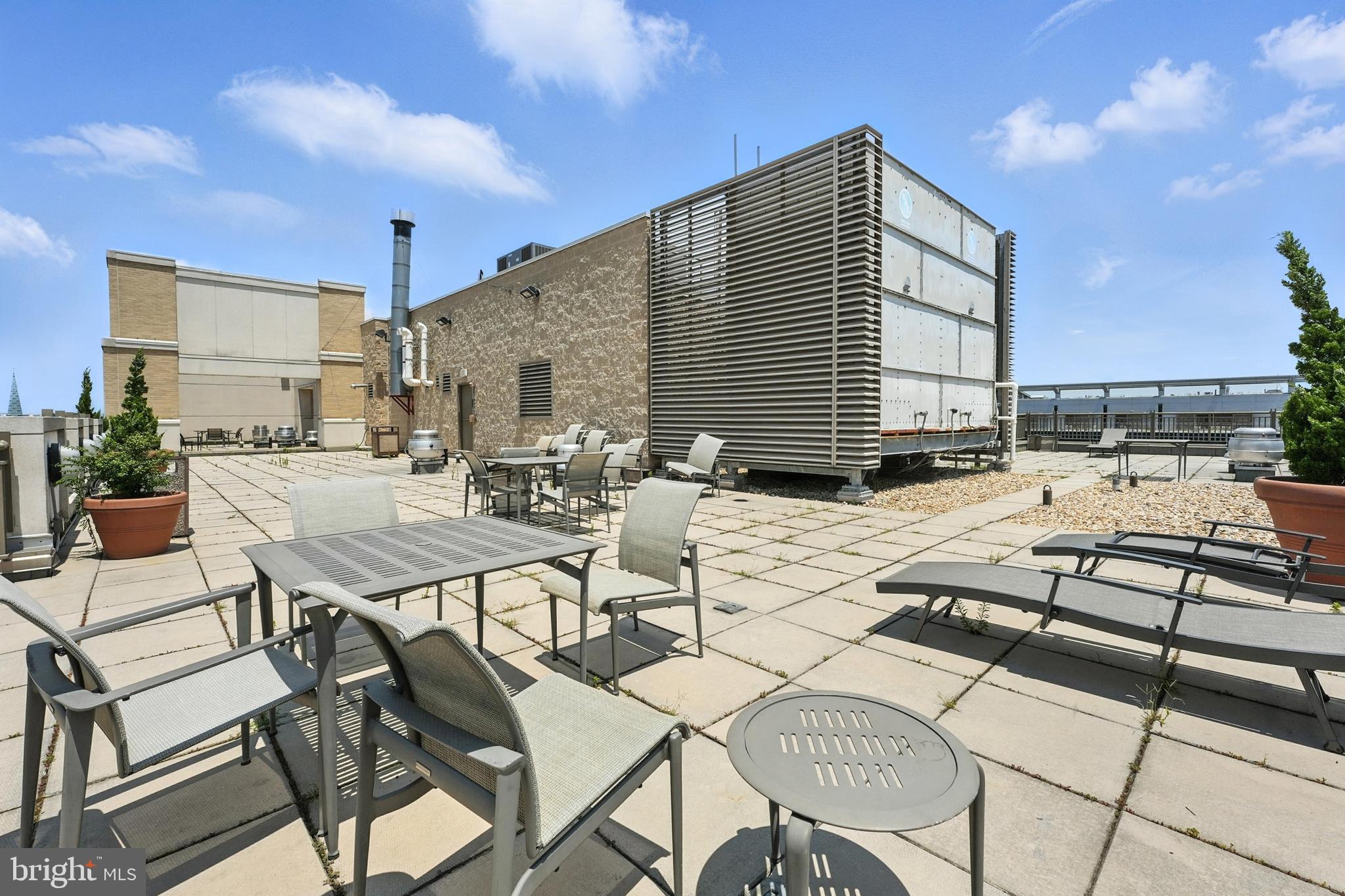 1150 K Street Northwest, Unit 1207 Washington, DC 20005 - Photo 26 of 29 a view of a dinning table and chairs in the patio