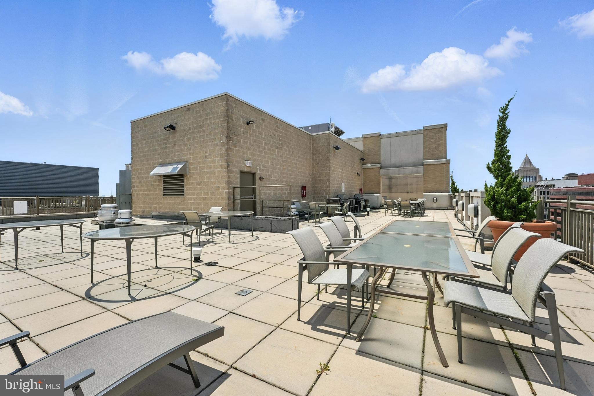 1150 K Street Northwest, Unit 1207 Washington, DC 20005 - Photo 28 of 29 a view of a patio with table and chairs and potted plants