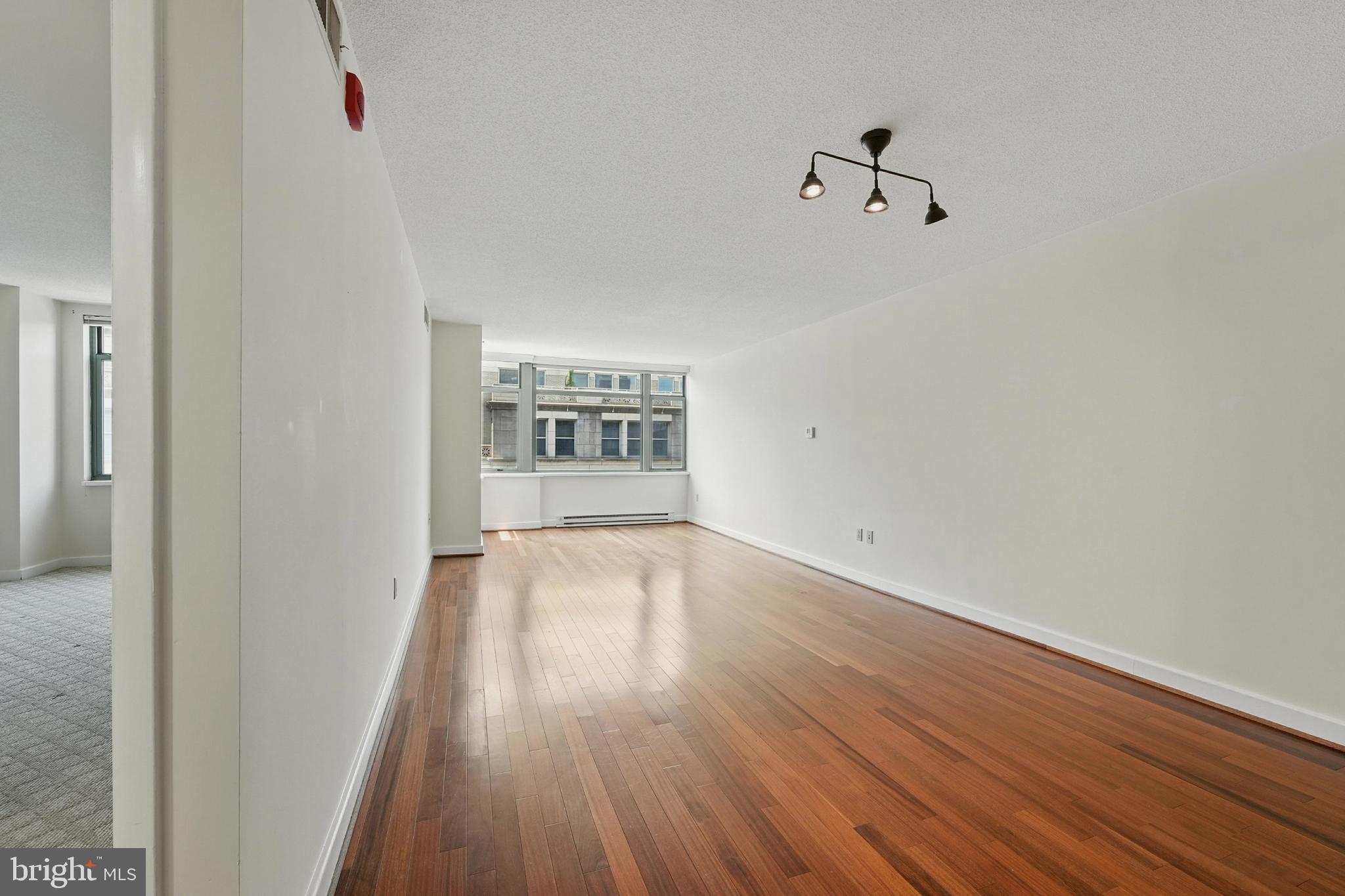 1150 K Street Northwest, Unit 1207 Washington, DC 20005 - Photo 9 of 29 a view of empty room with wooden floor
