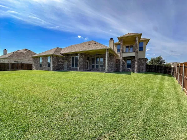 a view of a house with a yard and sitting area